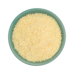 Parmesan cheese in a green bowl top view on a white background.