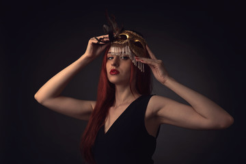  woman with gold carnival mask