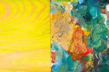 Painting palette on colored wooden background