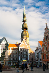 Old town square in the center of Riga, Latvia. Tourist attractions House of Blackheads and St Peters church.