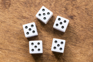 Number five dice on wooden table