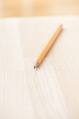 Yellow pencil on wooden table