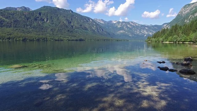 Amazing Bohinj Lake in morning. Deep clear water with fish and gorgeous landscape of Julian Alps. Triglav National Park, Slovenia, Europe.