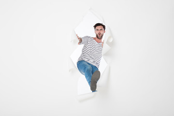 casual man breaking the paper background