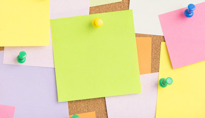 Empty blank sticky notes on notice board in office. Background or backdrop for business information. Concept image of communication or reminder with copy space.