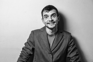 Close up of a funny young man in a jacket  with different emotion. The collage of young man in a jacket with different emotion. emotional card. black and white photo. 