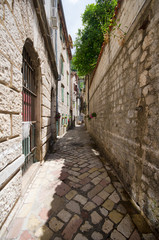 Old stone buildings in historical part of city Kotor in Montenegro with little streets.