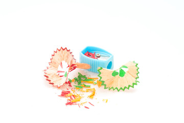 Colorful pencil shavings on white background.