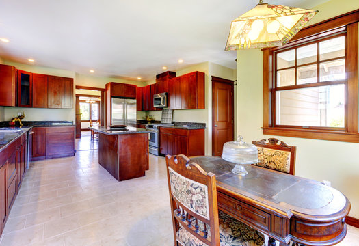 Large wood kitchen with dining room table.