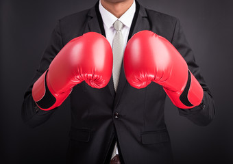Young businessman with boxing gloves
