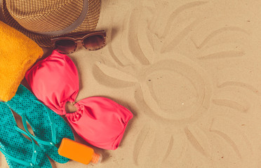 Fototapeta na wymiar Holiday accessories on sand beach