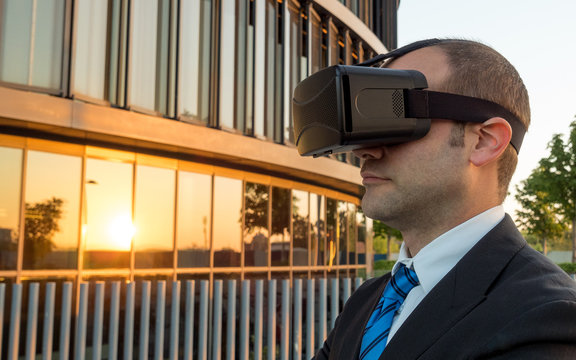 Businessman using virtual reality glasses in a business center