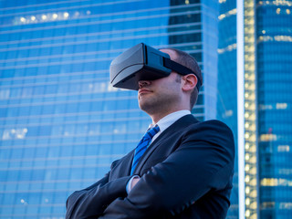 Confident businessman using virtual reality glasses in a busines - 117442157