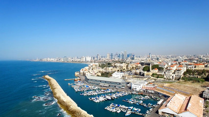 Tel Aviv's modern skyline with Jaffa's ancient port and old city - Aerial image