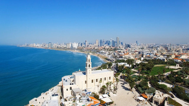 Tel Aviv's modern skyline with Jaffa's ancient port and old city - Aerial image