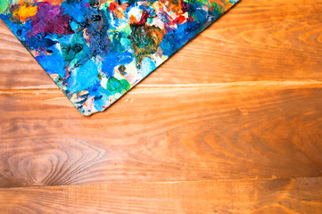Painting palette on wooden background