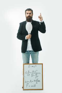 bearded man with einstein formula and newtons law