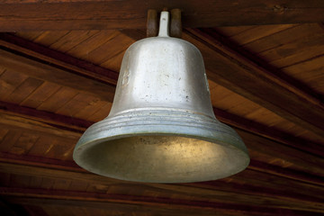 shiny bell hanging on wooden ceiling - Powered by Adobe