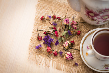 Vintage cup of tea with buds of roses