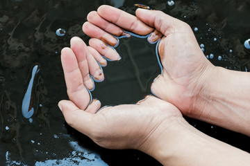crude oil in hand due to crude oil leak.crude oil spill concept.