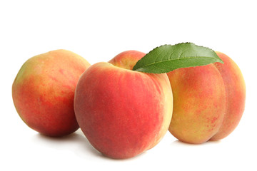 Peaches with leaf on white isolated background