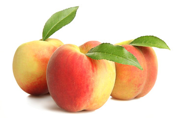Fototapeta na wymiar Peaches with leaf on white isolated background