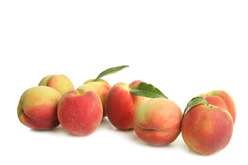 Peaches with leaves on white isolated background.