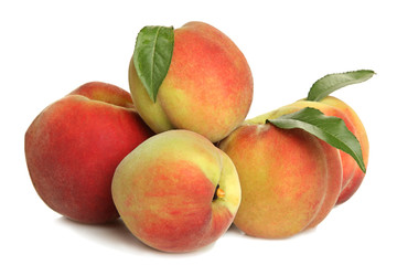 Peaches with leaves on white isolated background.