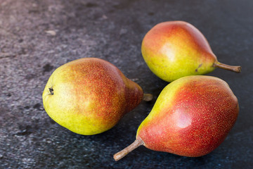  Juicy ripe pears on a blue-purple background.