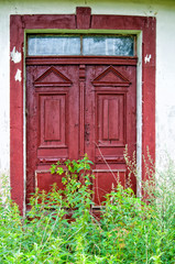 Old door of an abandoned house in the countryside
