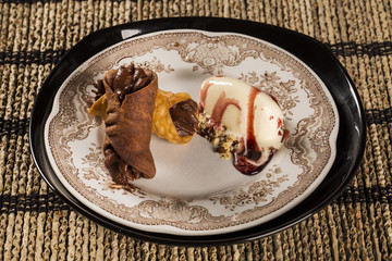 Cannoli with ice cream, chocolate and almonds