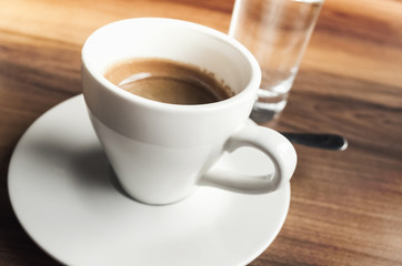 Fototapeta na wymiar Espresso coffee and small glass of water