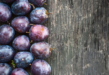 ripe plum on a wooden background