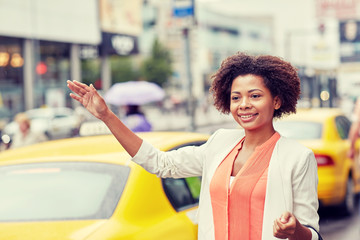 happy african woman catching taxi