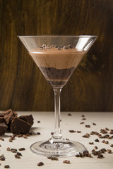 Chocolate mousse in a glasses on a wooden background