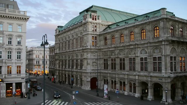 View of State Opera in Vienna, Austria during the night. Cloudy sunset sky, car traffic