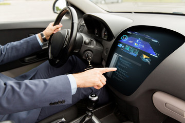 close up of man driving car with navigation system