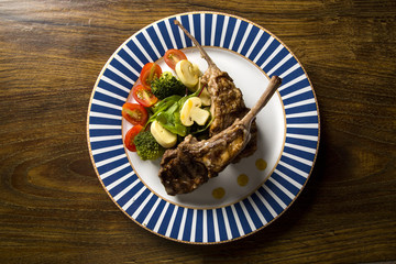 Rare fried rack of lamb with vegetables.