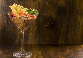 mixed fish Ceviche with salmon, onion and pepper. Traditional pe