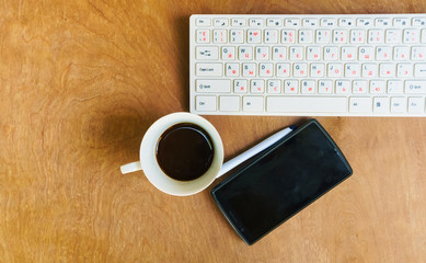 Office desk table with computer, supplies and coffee cup