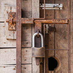 Close up old wooden door with lock