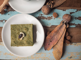Matcha green tea brownie cake on wooden table/ Food concept