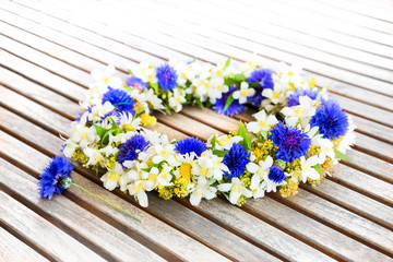 Floral wreath on wooden table.