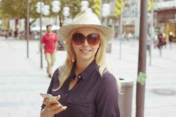 Woman with sun hat in the city