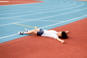 Boy lay on the running track