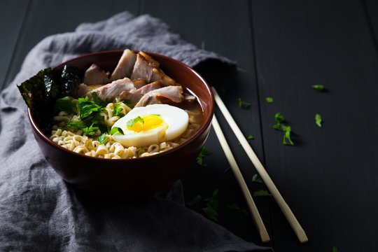 Asian noodles with pork, egg and greens