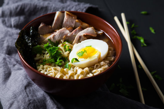 Asian noodles with pork, egg and greens