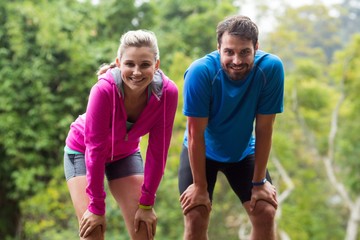 Fototapeta na wymiar Tired couple taking a break while jogging