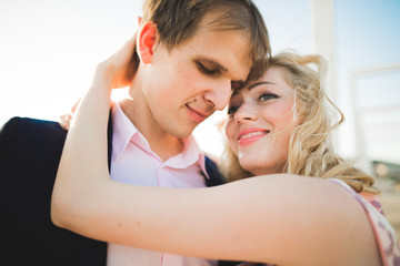 Close up portrait of happy smiling couple in love posing on roof with big balls. Landscape  city