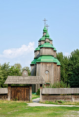 Old wooden church with green domes